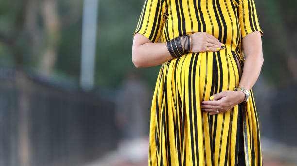 Pregnant women standing with side copy space