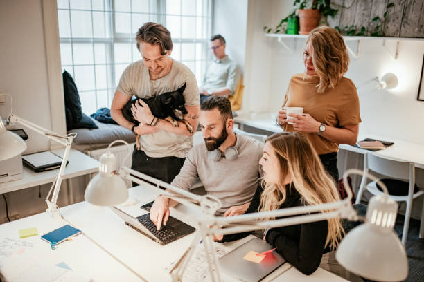 istock Pet-friendly office with diverse employees 1180171332