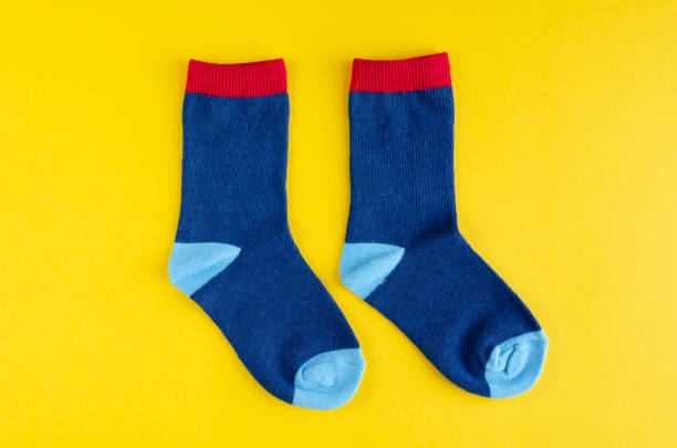 istock Cotton kids socks composition on yellow background. 1180171868