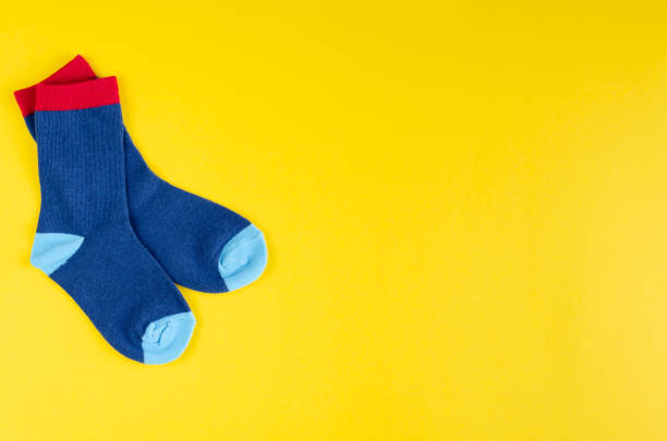istock Cotton kids socks composition on yellow background. 1180171879