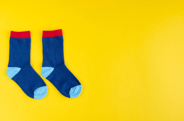 istock Cotton kids socks composition on yellow background. 1180171900