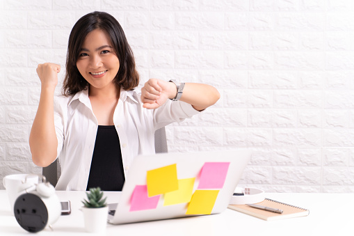 Happy woman holding hand with wrist watch