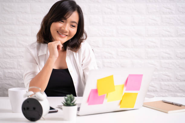 istock Happy woman sitting at home office working using computer laptop 1180172593