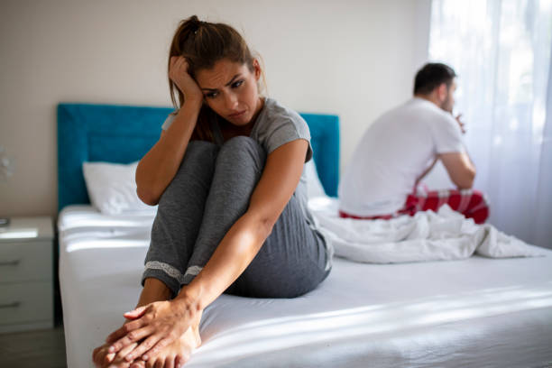 Couple in conflict standing sad in the bed. Unhappy Married Couple and Sexual Problems Concept. Frustrated Man and Woman Not Talking Feeling Offended or Stubborn. Concept of Impotence. Man Have Problems. human sexual behavior stock pictures, royalty-free photos & images