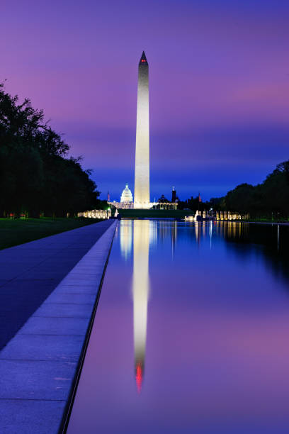 New day with pastel color sunrise sky over Washington DC, View of Washington Monument, Capitol Building reflecting in Reflection Pool New day with pastel color sunrise sky over Washington DC, View of Washington Monument, Capitol Building reflecting in Reflection Pool washington monument reflecting pool stock pictures, royalty-free photos & images
