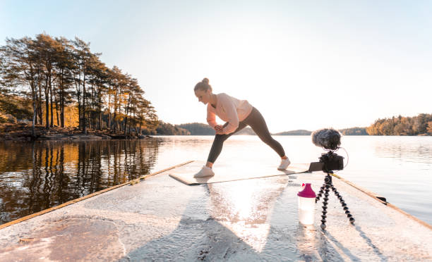 istock Woman recording a vlog while exercising 1180175802