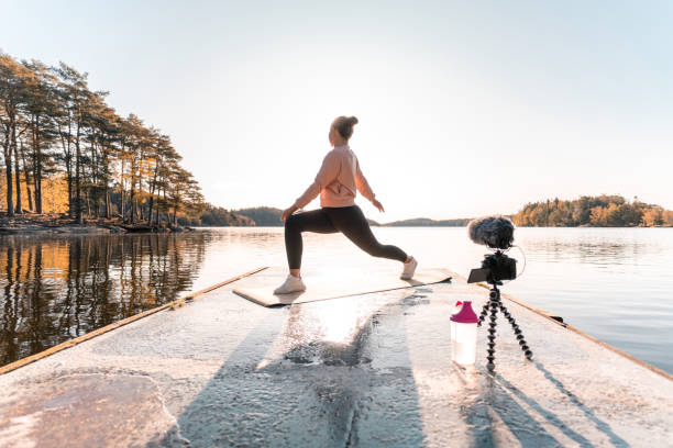 istock Woman recording a vlog while exercising 1180175805