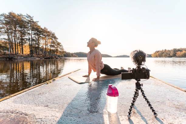 istock Woman recording a vlog while exercising 1180175811