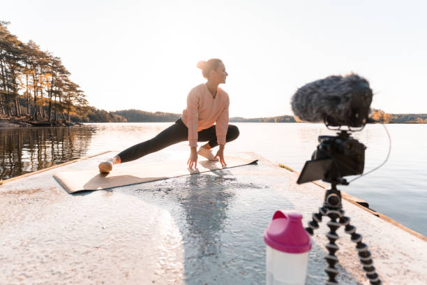 Woman recording a vlog while exercising