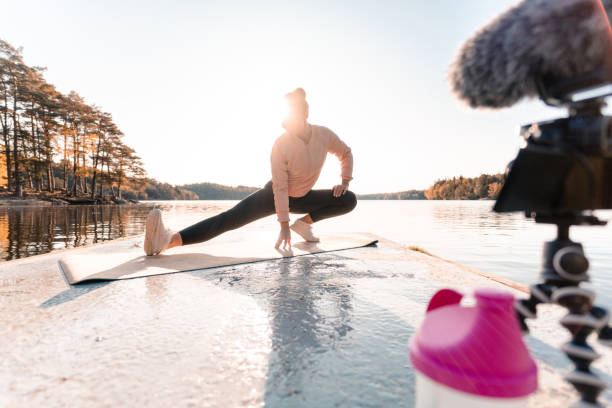 istock Woman recording a vlog while exercising 1180175816