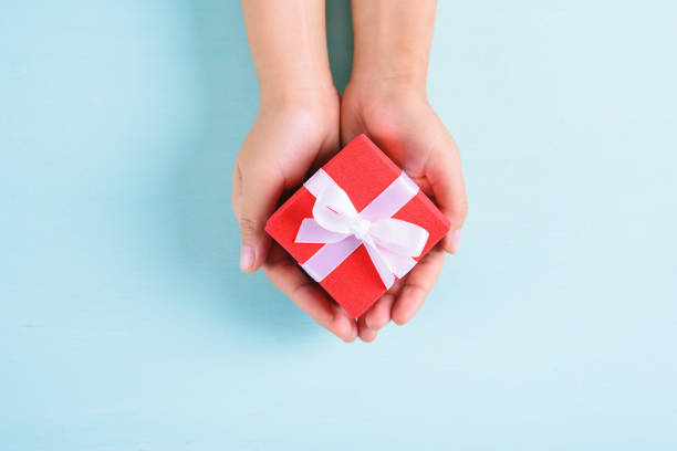 istock Red gift box in hand for giving 1180177633