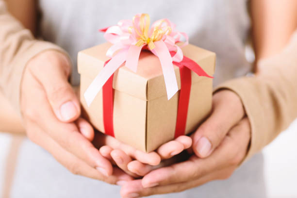 istock Couple hand holding gift box together 1180178290