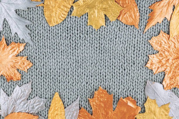 istock Autumn composition with golden leaves frame on knitted gray background. Fall mockup with gold maple leaves. Flat lay, top view, copy space. 1180178713