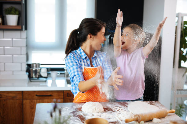 istock Happy family in the kitchen making cookies 1180180371