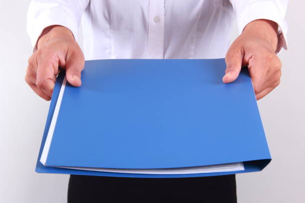 istock Businesswoman holding file folder 1180180405