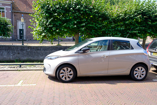 Renault Zoe full electric car parked in the street of Amersfoort, The Netherlands next to a canal.