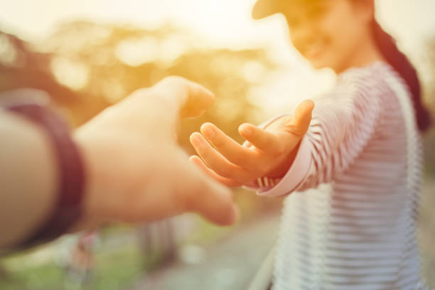 Girl teen smiling and reach her hand. Help Touch Care Support be a Good Friend with Love concept. Girl teen smiling and reach her hand. Help Touch Care Support be a Good Friend with Love concept. reaching stock pictures, royalty-free photos & images