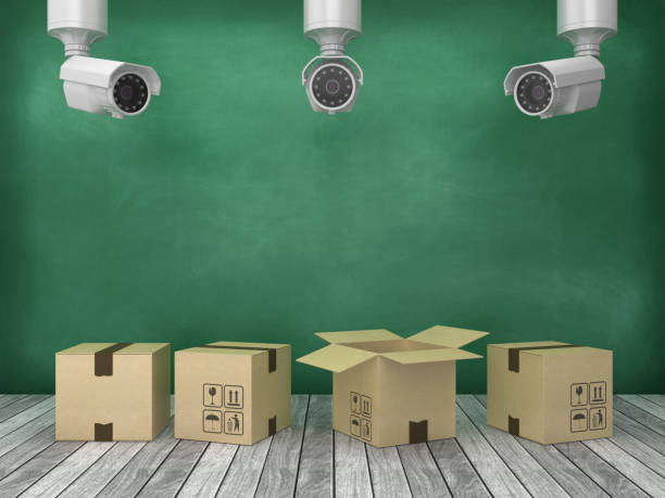 istock Cardboard Box with Security Cameras on Wood Floor - Chalkboard Background - 3D Rendering 1180183040