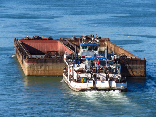 istock Top view of Tugboat pushing a empty barge on the river 1180183069