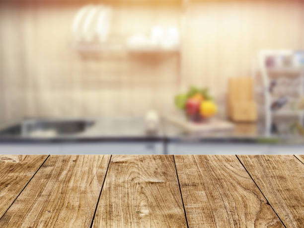 istock Wood table top in kitchen room blur background for montage product display or backdrop design layout. 1180187040