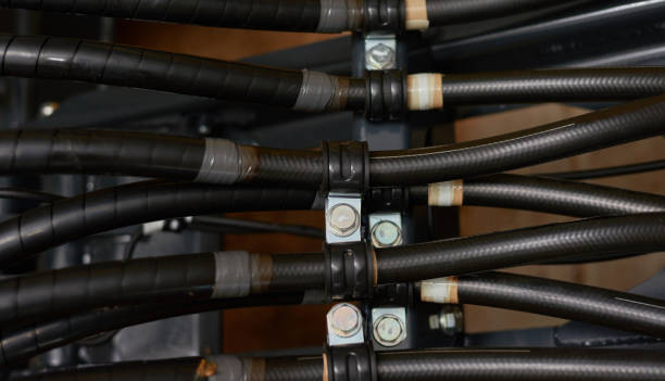 Close up view of hydraulic pipes of heavy industry machine. Low key. Close up view of hydraulic pipes of heavy industry machine. Low key. Hydraulic maintenance concept. hydraulic hose stock pictures, royalty-free photos & images