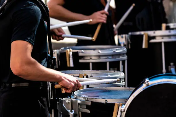section of a marching band drum line performing