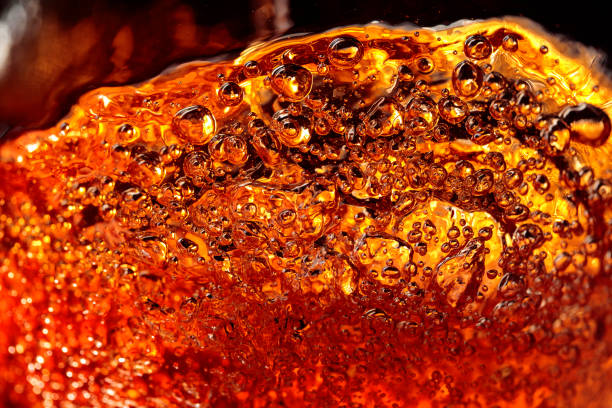 istock Alcoholic drink on a dark background, abstract splashing. 1180188651