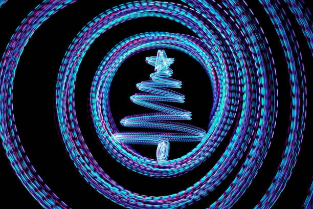 LED light painted Christmas tree in circles isolated on a black background. Multi colored.
