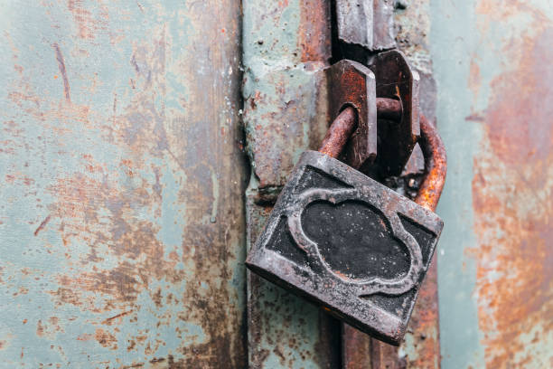 istock Rusty padlock locks the old gate of an abandoned hangar 1180192164