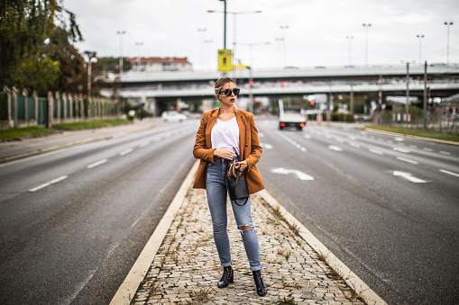 Young woman standing in the middle of the road