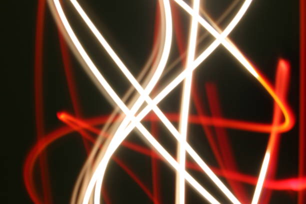 istock Abstract colorful irregular lines on black / green background photo with long exposure . Light painting photography. Lights with irregular patterns for overlay 1180194476