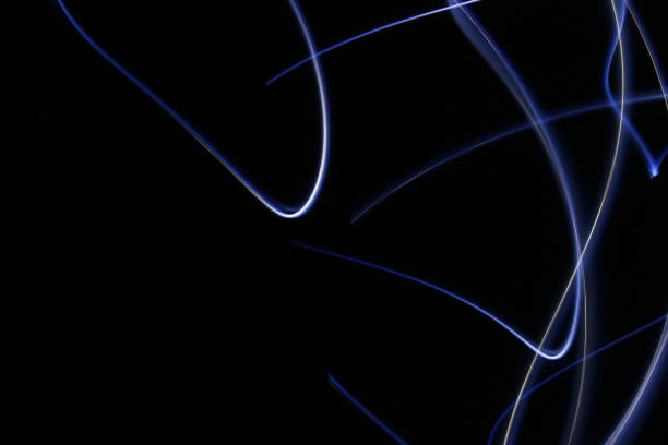 istock Abstract colorful irregular lines on black / green background photo with long exposure . Light painting photography. Lights with irregular patterns for overlay 1180194656