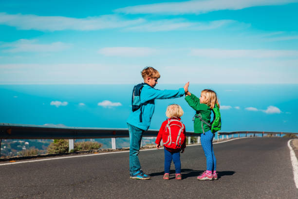 istock happy kids high five on road in mountains 1180196015