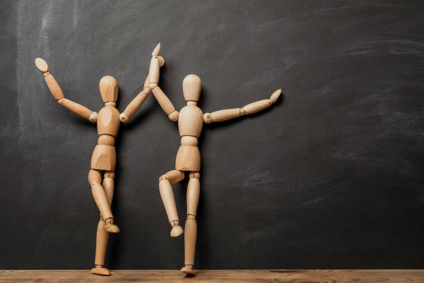 istock Two dancing wooden figures on the background 1180197204
