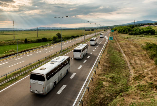 istock Four buses in line traveling on a highway 1180197290