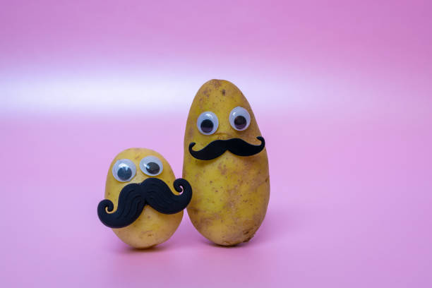 istock funny potato head with face on pink background 1180197304