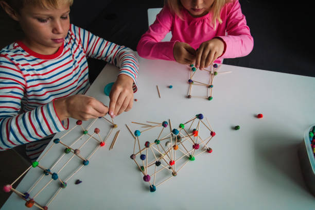 istock kids making geometric shapes, engineering and STEM 1180197401