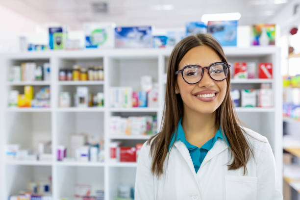 Pharmacist working at the drugstore Portrait of a smiling healthcare worker in modern pharmacy. technician stock pictures, royalty-free photos & images