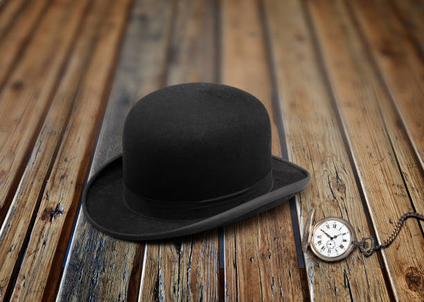 istock A stylish black bowler hat  and old clock 1180198791