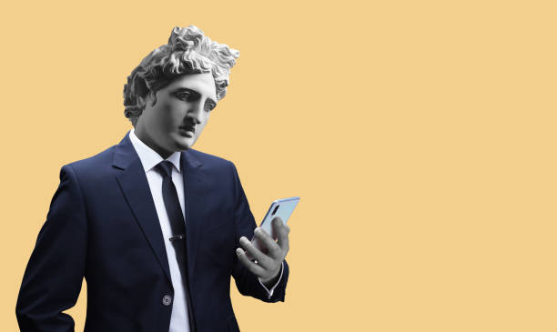 istock Modern art collage. Concept portrait of a  businessman  holding mobile smartphone using app texting sms message. Gypsum head of of Apollo. Man in suit. 1180200032