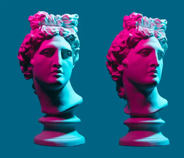 Photo of Statue neon. On a blue isolated background. Gypsum statue of Apollo's head. Man.