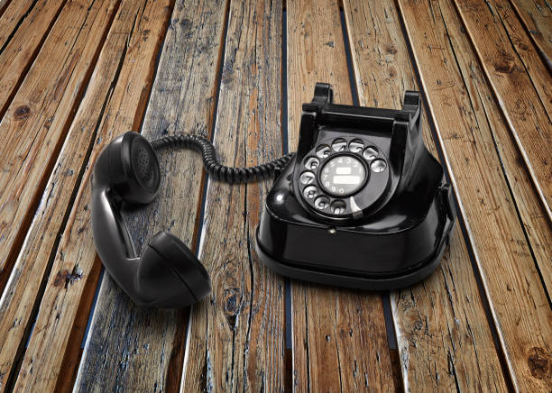 istock Old telephon with rotary dial on textured wooden table 1180200109