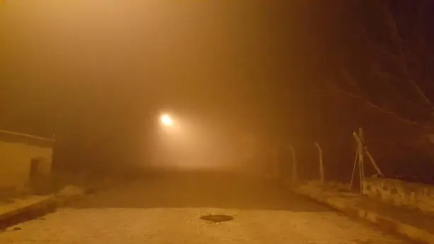 Empty and deserted street, foggy night and streetlight, yellow, dim environment
