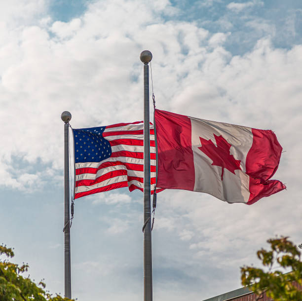 istock American and Canadian Flags 1180202387