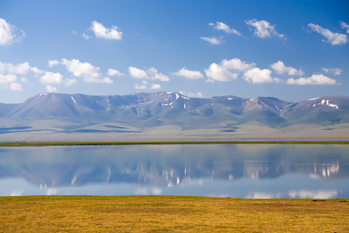 A view Songkol lake in central Republic of Kurgyzstan in summer time. Popular tourist destination in central Asia.