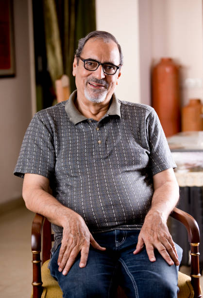 istock Old man sitting on chair 1180205826