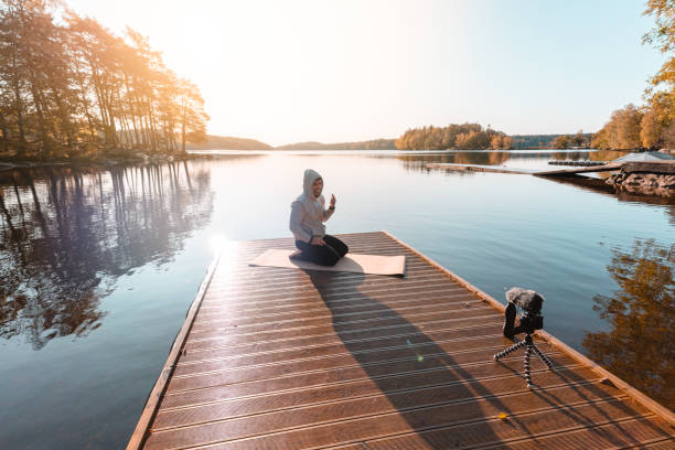 istock Exercise influencer recording a workout video outdoors 1180205915