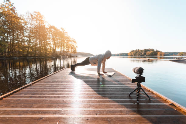 istock Exercise influencer recording a workout video outdoors 1180205916