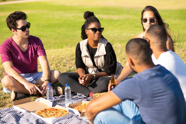 istock Multiethnic friends eating pizza outdoors 1180207391