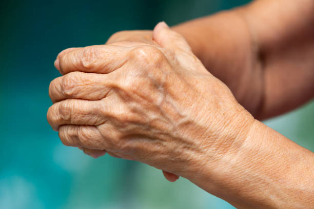 istock Senior woman's touching her hands and praying, Close up & Macro shot, Selective focus, Asian Body skin part, Body language feeling, Religious concept 1180208366